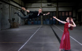 Magician flying through the air during a magic show performance.