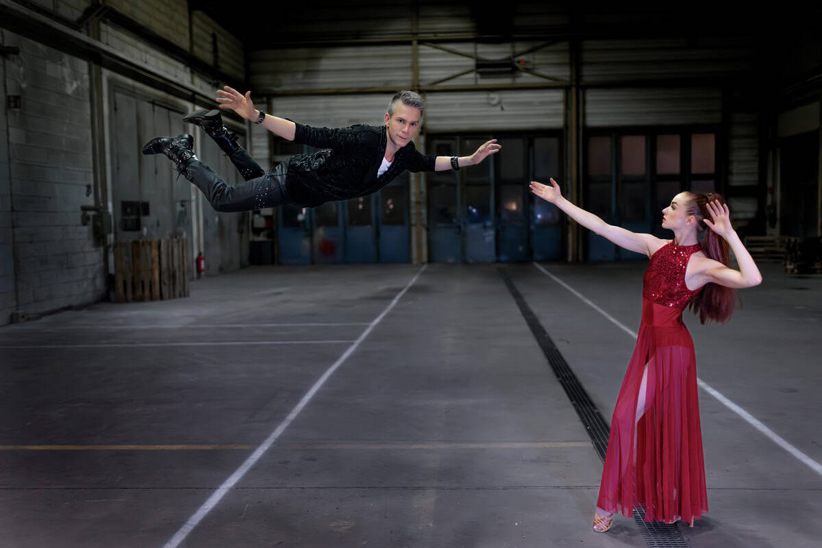 Magician flying through the air during a magic show performance.