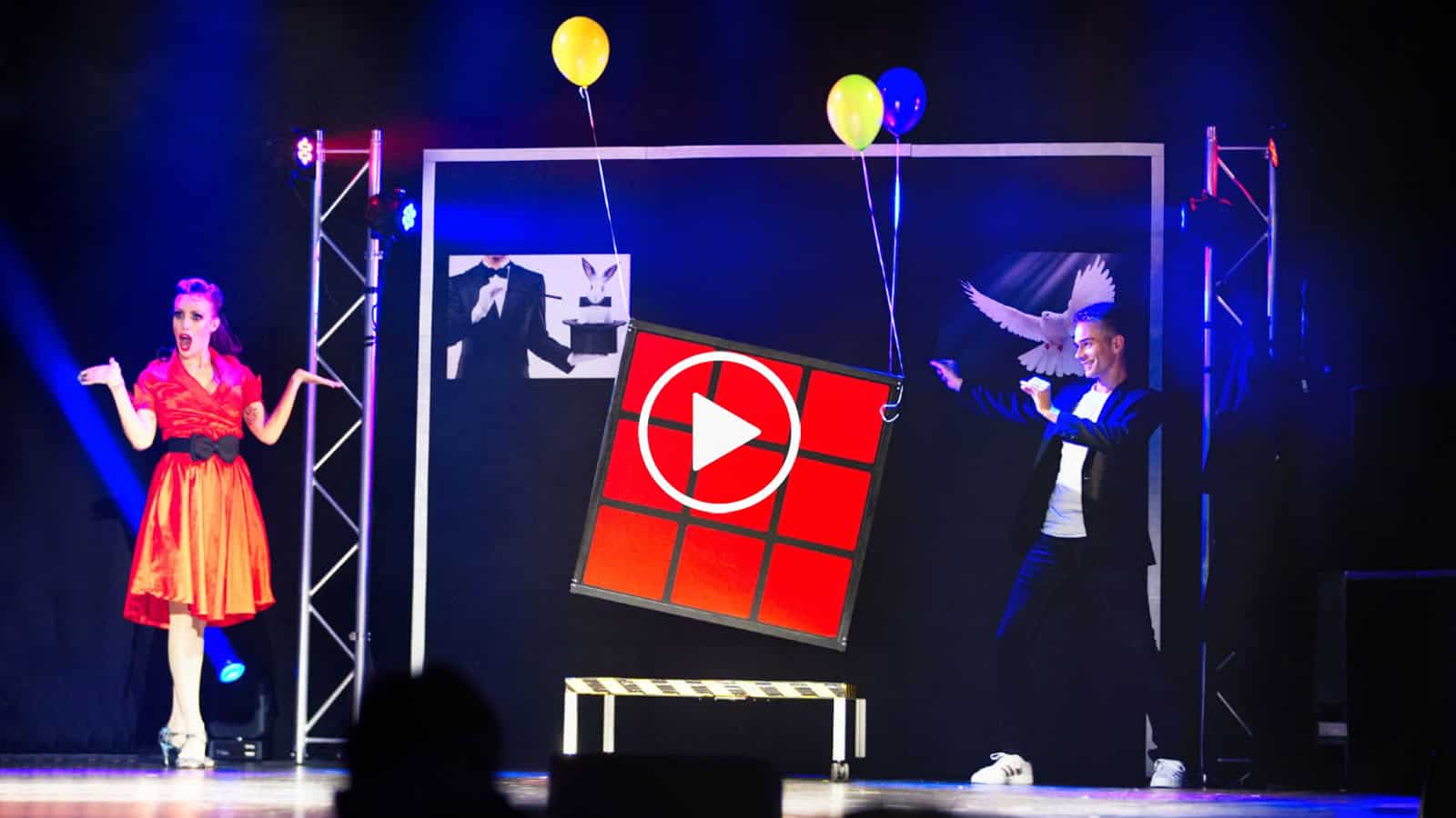 Magician & Illusionist – THE MAGIC MAN Magician performing illusions with balloons on stage at THE MAGIC MAN show.